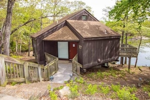 This modern elevated home offers a unique "treetop" living experience, blending seamlessly with the surrounding lush natural landscape. Multiple large windows allow for abundant natural light and scenic views, making this a bright and inviting retreat.