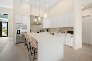 Spacious White Kitchen with Breakfast Bar