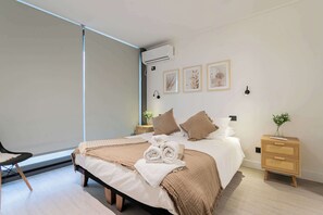 Relax in this serene bedroom with modern decor and cozy ambiance, perfect for unwinding after a day of exploring.
