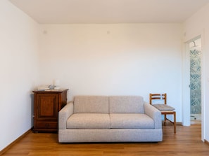 Furniture, Interior Design, Flooring, Floor, Couch, Wall, Wood, Room, Wood Flooring, Living Room
