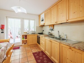 Interior Design, Kitchen, Wood, Furniture, Cabinetry, Flooring, Kitchen Appliance, Floor, Room, Countertop