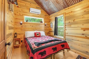 The cabin features two bedrooms with queen beds.