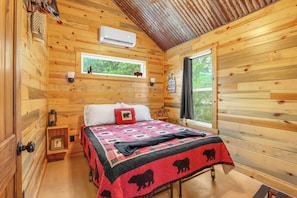 The cabin features two bedrooms with queen beds.