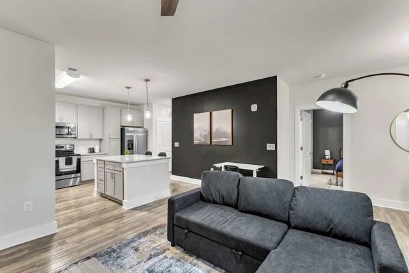 Enjoy evenings filled with laughter and conversation in this spacious living room, where every detail is crafted for the ultimate hosting experience.