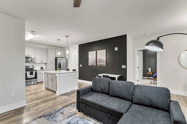Enjoy evenings filled with laughter and conversation in this spacious living room, where every detail is crafted for the ultimate hosting experience.