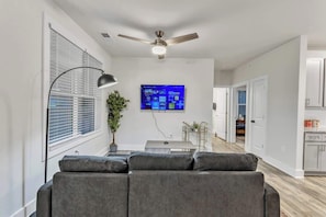 Enjoy evenings filled with laughter and conversation in this spacious living room, where every detail is crafted for the ultimate hosting experience.