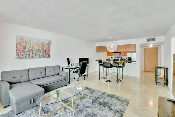 Spacious living area with cozy seating and smart TV - perfect for relaxing or streaming your favorites.