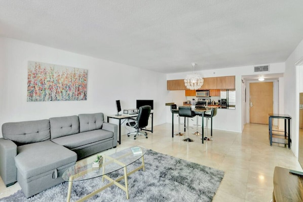 Spacious living area with cozy seating and smart TV - perfect for relaxing or streaming your favorites.