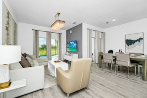 Spacious living room with comfy seating and Smart TV for ultimate relaxation.