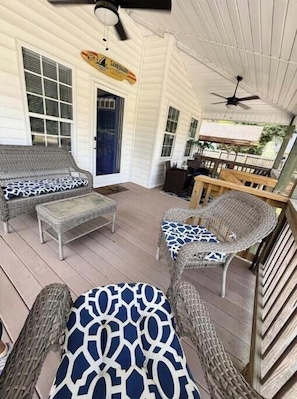 Large front porch with ceiling fans. Two areas to sit on each side of porch.