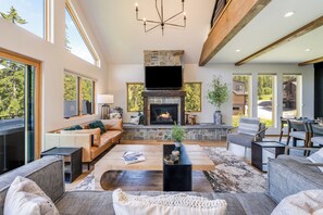 Spacious living room with stone fireplace to get cozy by | Main Level