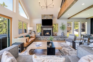 Spacious living room with stone fireplace to get cozy by | Main Level