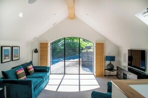 Sunny living room with west facing arched window