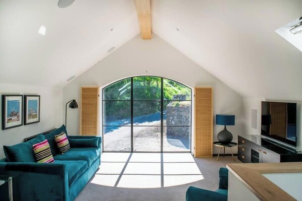 Sunny living room with west facing arched window