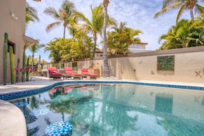Private heated pool area featuring a hot tub and comfortable lounge chairs for ultimate relaxation.