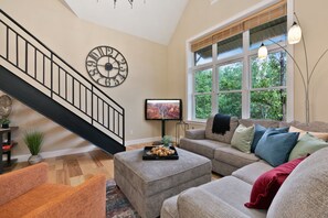 Living Area with Vaulted Ceilings | Stairway to Loft-style Bedroom