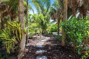 The home is surrounded by private gardens with walking paths.
