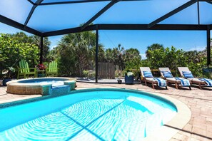 Soak up the sun in style—this inviting fully screened pool area features crystal-clear water and comfortable lounge chairs, perfect for relaxing under the Florida sun.