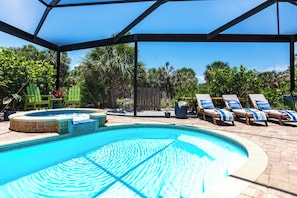 Soak up the sun in style—this inviting fully screened pool area features crystal-clear water and comfortable lounge chairs, perfect for relaxing under the Florida sun.
