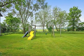 A kid-friendly paradise with swings, slides, and space to roam.