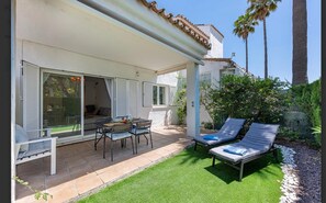 Beautiful private backyard with outdoor dining set and sun loungers to enjoy the sun. (1)