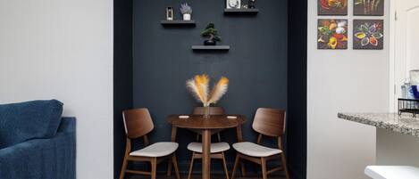 Cozy dining area with round table and seating for three.