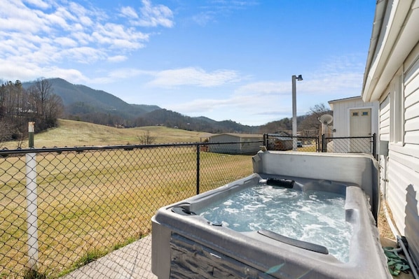 The back patio has a relaxing hot tub and beautiful Smoky Mountain Views.