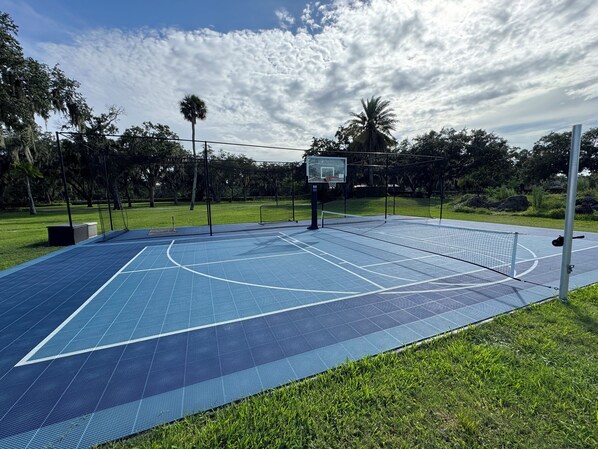 Sport court with pickle ball, basketball, and batting cage