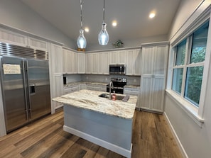 Kitchen with stainless steel appliances and kitchen island