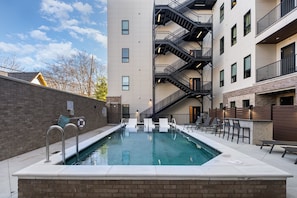 Communal Area: A tranquil pool area with sun loungers, perfect for guests to relax and soak up the sun.