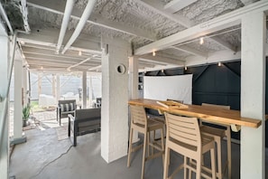 Fun hangout space under the home with games and seating.