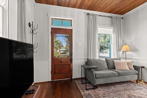 Bright living space with cozy couch and vintage accents.
