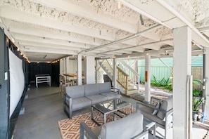 Outdoor sitting nook under the house with plenty of shade.