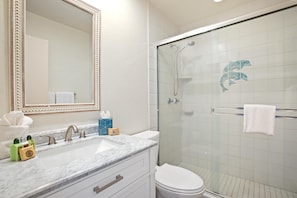 LOK-B201 Polished chrome fixtures and a marble-topped vanity blend timeless elegance with breezy comfort in this coastal retreat