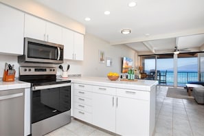 LOK-B201 Crisp white cabinets and breezy light make this kitchen feel like a cloud where recipes float and flavors sing