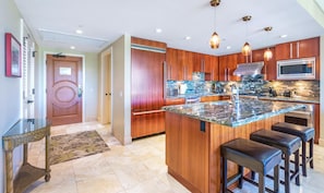 HKH-603 Sleek island kitchen with luxe finishes and bar seating.