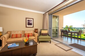 HKH-423 Stylish living space with warm tones, tropical floral, and seamless transition to your private Maui balcony