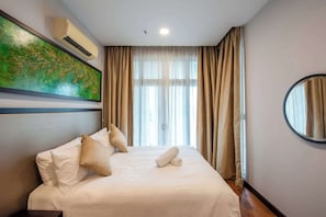 A 2nd bedroom with a queen-sized bed & plush pillows.