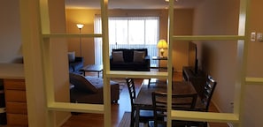 The living room comes furnished with essential pieces, including a comfortable sofa, a coffee table, and a TV stand, providing immediate comfort upon move-in.
