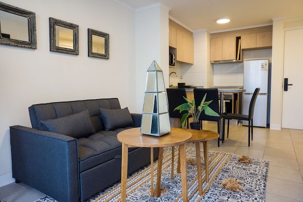 Cozy studio with modern decor and a functional kitchenette, perfect for a comfortable stay in the heart of Chile.