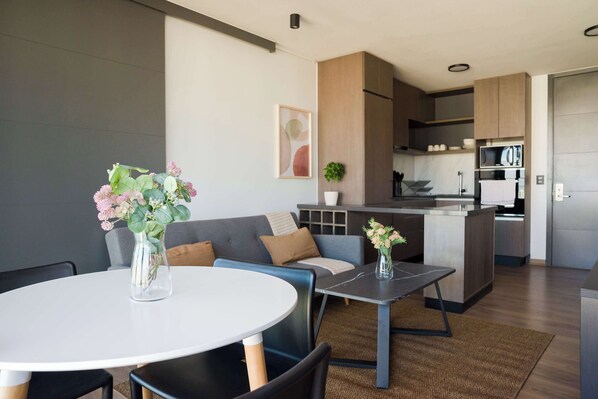 Chic open-plan living space with modern decor and a cozy vibe, perfect for relaxing after a day of exploring.
