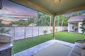 Back patio with outdoor seating and grill