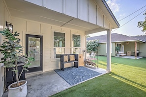 Back patio with outdoor seating and grill