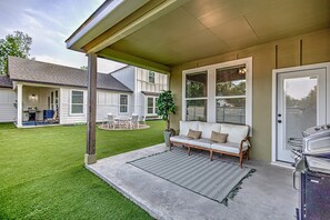 Lakin' It Easy back patio with outdoor seating and grill