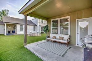 Lakin' It Easy back patio with outdoor seating and grill