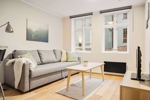 Multi-functional space with a comfortable sofa and bright natural light.