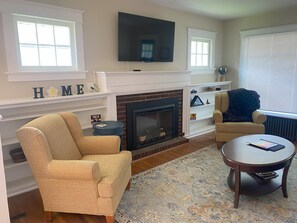 Living room with Smart TV and electric fireplace.