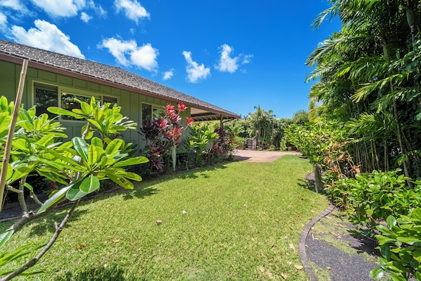 Front lawn path framed by lush landscaping—welcoming entry to your island sanctuary.