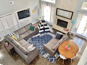 Living room from stair landing. TV is in the built in cabinets.