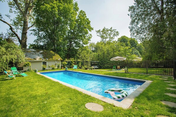 A serene escape - our private pool with lush fenced in yard.